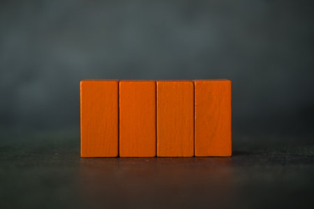 Four rectangle wood orange blocks on a background with copy spaceの写真素材