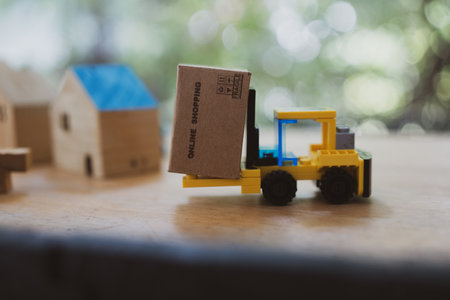Forklift and cardboard box against nature background. Online shopping conceptの写真素材
