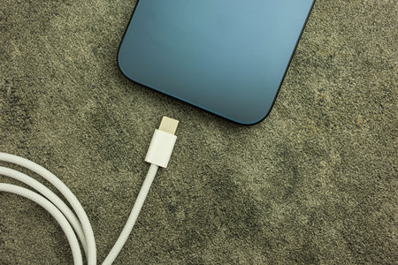 Bangkok, Thailand - October 16, 2023 : Usb type C cable charger a iPhone 15 Pro blue Titanium. Top...