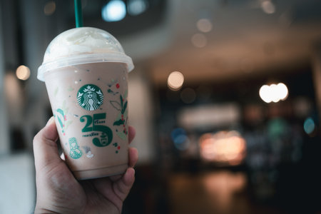 Bangkok, Thailand - October 16, 2023 : Starbucks iced Mocha with whipped cream, designed cup in the 25th Anniversary, get 1 free when purchasing any type of beverage, size 12 ounces or more. Limited-editionのeditorial素材