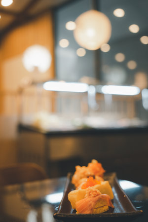Japanese cuisine set of sashimi sushi set served on a tray with light bokehの写真素材