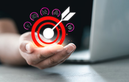 Man hand holding icons target board for successful marketing set up business objective target....