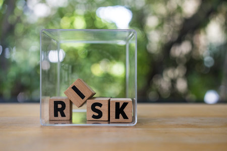 Wooden cubes with risk words in the box. Risk management concept. Four wood cubes with white letters...