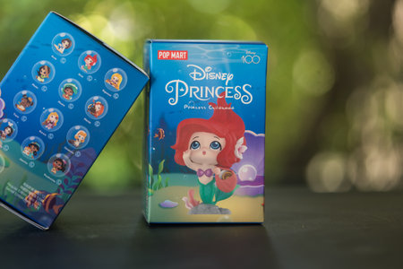 Bangkok, Thailand - October 27, 2023: Two box of POP MART Disney 100th anniversary Princess Childhood Series Figures Blind Box against nature backgroundのeditorial素材