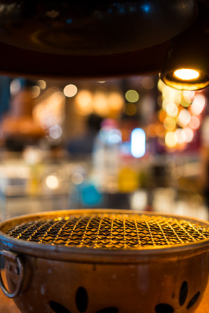 Barbecue charcoal grill stove or charcoal stove in Korean style restaurant. Close up
