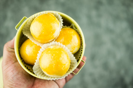 Chinese flaky pastry or moon cake filled with sweet mung bean paste and salted egg yolk. Homemade bakery concept.の写真素材