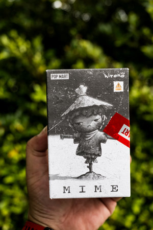 Bangkok, Thailand - November 4, 2023: A box of toy figure POP MART x HIRONO MIME Series on man hand.のeditorial素材