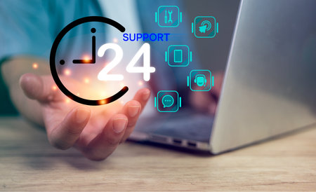 The technician hand holding icon of 24 hours and call center symbol on screen. Technical support service, question, information center or chat with staff. Care and consulting client 24hr.の写真素材