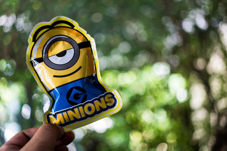 Bangkok, Thailand - November 11, 2023 : Han holding of a package of toy from MINISO of a collection is Minions Q-TOPPING 1.0のeditorial素材