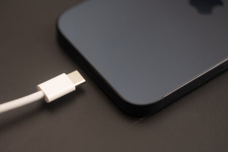 Bangkok, Thailand - November 11, 2023 : Usb type C cable charger a iPhone 15 Pro blue Titanium on a black backgroundaのeditorial素材
