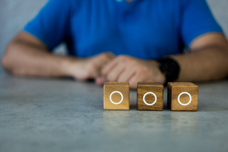 Man with three wood blocks with an empty circle for the list of three options. Checklist or to do list in business conceptの写真素材