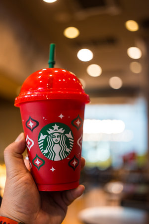Bangkok, Thailand - November 21, 2023: Christmas Reusable Cup at Starbucks Thailand when purchasing Starbucks beverage 16 oz. or above. Starbucks coffee drink in the 2023 designed red cup for Christmasのeditorial素材