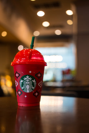 Bangkok, Thailand - November 21, 2023: Christmas Reusable Cup free for when purchasing any Starbucks beverage 16 oz. or above, designed in the 2023 designed red cupのeditorial素材