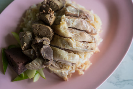 Rice steamed with chicken soup and offal with cucumber, sale at Thai street food market or restaurant in Thailandの写真素材