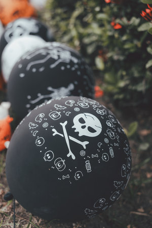Halloween black balloons decorated in garden. Halloween party activity ideasの写真素材