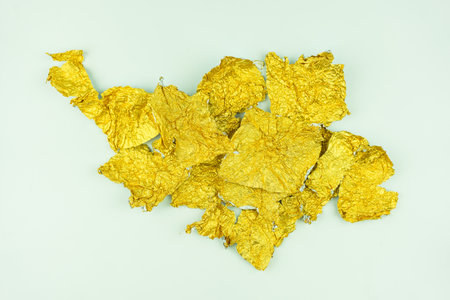 Candy golden wrapper is empty and open. Gold foil after eat candyの写真素材