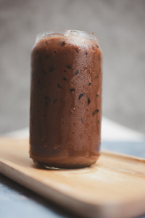 Iced mocha glass in the morning served on wood tray. Freshness with caffeine in coffee.の写真素材