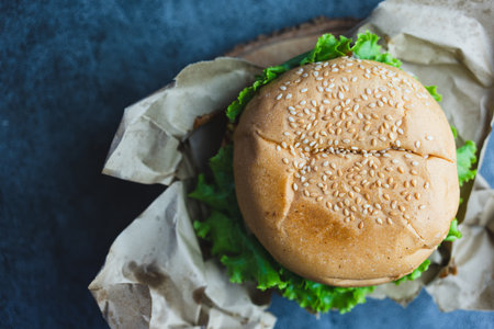 Delicious fresh and tasty pork hamburger with lettuce in eco packaging. Close upの写真素材