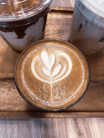 Hot coffee with latte art on wood backgroundの写真素材