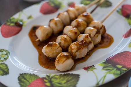 Grilled meatballs with sweet sauce, Thai street food style.