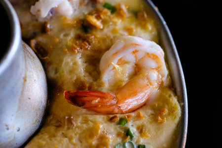 Steamed egg boiled in a fire pot with shrimp. Top viewの写真素材