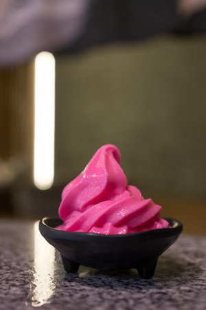 Closeup tasty raspberry or strawberry soft serve in black bowlの写真素材