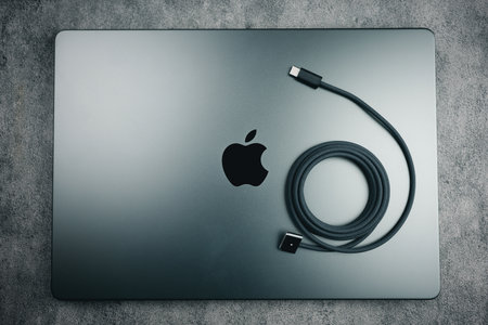 Bangkok, Thailand - December 5, 2023 : Space Black M3 Max MacBook Pro size 14 inches with black braided USB C port for fast charge placed on topのeditorial素材