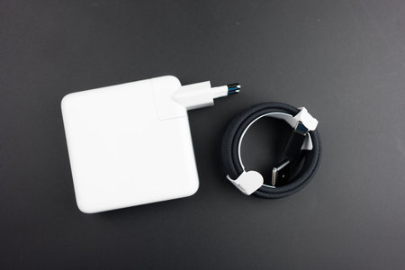 Bangkok, Thailand - December 5, 2023 : Power adapter 96 watts with black braided USB-C cable for charger new MacBook Pro M3 Max on a black backgroundのeditorial素材