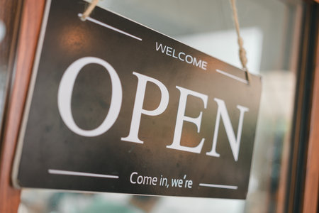 Open sign on a glass door, sign board hanging on glass door in cafe shop openの写真素材