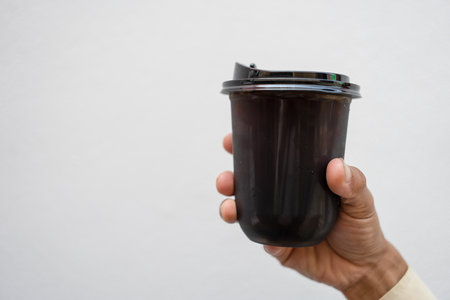 Iced black coffee or iced americano on man hand. Refreshing morning drinkの写真素材