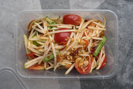 Green papaya salad or Thai called Somtum in box. Famous Thai foodの写真素材