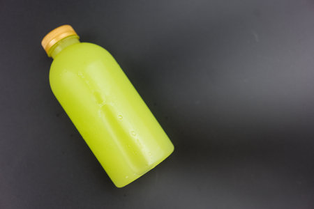 Fresh guava juice in a bottle on a black backgroundの写真素材
