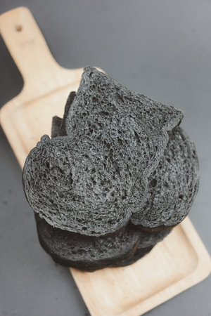 Organic charcoal bread or black bread on wood tray.の写真素材