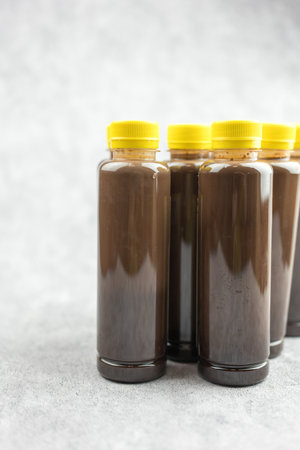 Close up cool fresh dark cocoa  in a plastic bottle with yellow lid quite popular take a homeの写真素材