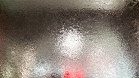 Close up abstract texture view of a car windshield in an automatic car washの写真素材