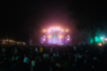 Blurred image people enjoying watching concert an outdoors music at night, community event, festival.の写真素材