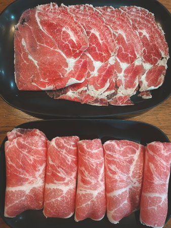 Raw beef finely sliced for cooking. Hot pot ingredients. Close upの写真素材