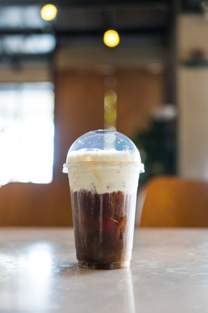 Glass of delicious black coffee with cream cheese. Refreshing summer drink.の写真素材