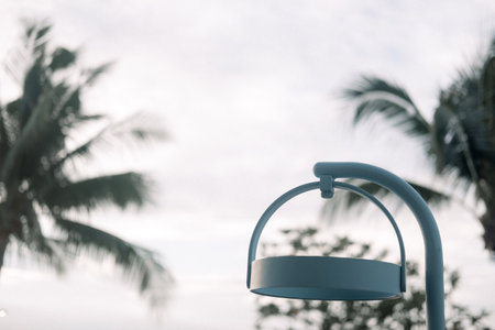 Outdoor lamp in daylight on a sky and tree backgroundの写真素材