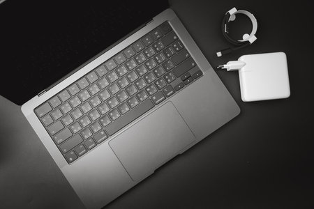 Bangkok, Thailand - December 15, 2023 : Close up of a Thai language keyboard of Apple MacBook Pro M3 Max, Space Black a dazzling new look placed with power adapter watts with black braided USB-C cableのeditorial素材