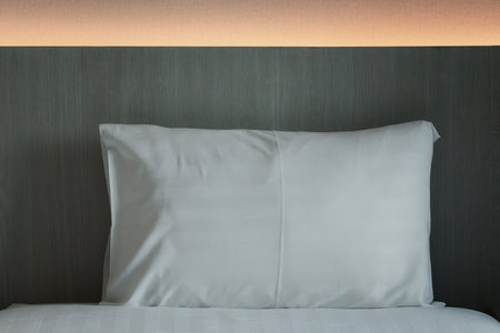 Close-up of white pillow on bed. White comfortable pillowの写真素材