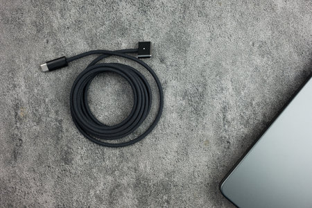 Bangkok, Thailand - December 16, 2023 : Black braided USB C port for fast charge cable came with Apple MacBook Pro M3 Maxのeditorial素材