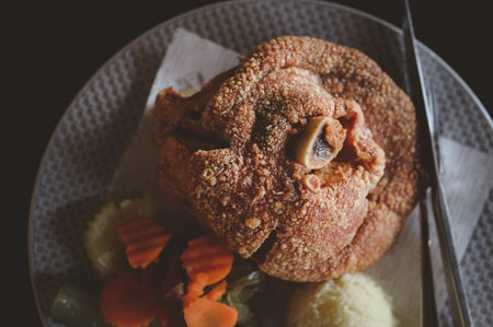 Deep fried pork knuckle eating with beer in restaurant. Top viewの写真素材