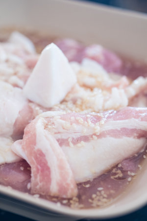 Streaky pork and bacon marinade sprinkle with white sesame for buffet hot pan, Moo Ka Taの写真素材
