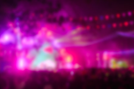 Blurred image people enjoying watching concert an outdoors music at night, community event, festival.の写真素材