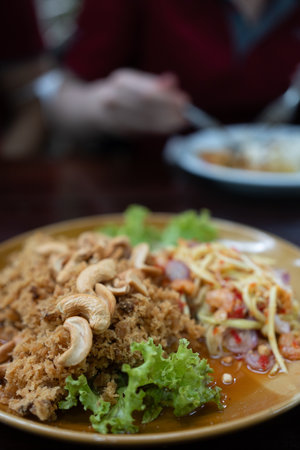 Spicy deep fried crispy catfish salad. Famous appetizer menu in Thai restaurant.の写真素材