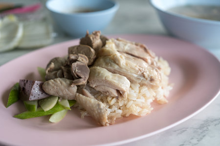 Boiled chicken, offal with cucumber sliced eating with rice and spicy or sweet sauce.の写真素材