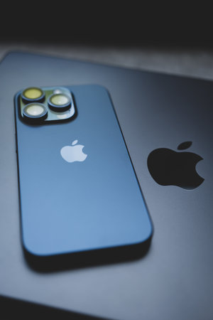 Bangkok, Thailand - December 24, 2023: iPhone 15 pro blue titanium placed on MacBook Pro, M3 Max 2023, Space Black colourのeditorial素材