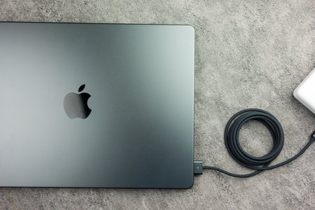Bangkok, Thailand - December 24, 2023 :  MacBook Pro 14 inch, M3 Max 2023 Space Black M3 Max with black charging cable plugged into a connectorのeditorial素材