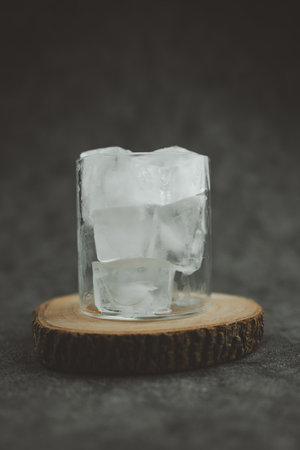 Ice cubes in transparent glass make from a freezer ice cube tray.の写真素材
